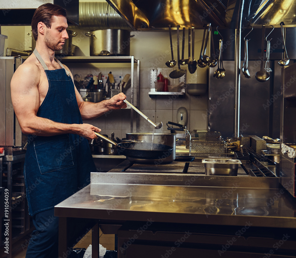 The chef preparing meat on a dry pan. The chef preparing meat on a dry pan.