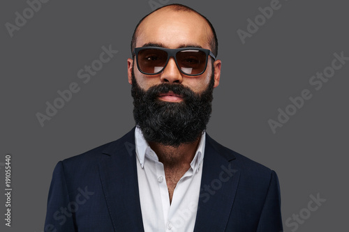 Portrait of a bearded male isolated on grey background.