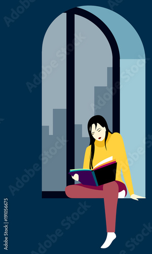 Young woman reading a book sitting on the windowsill