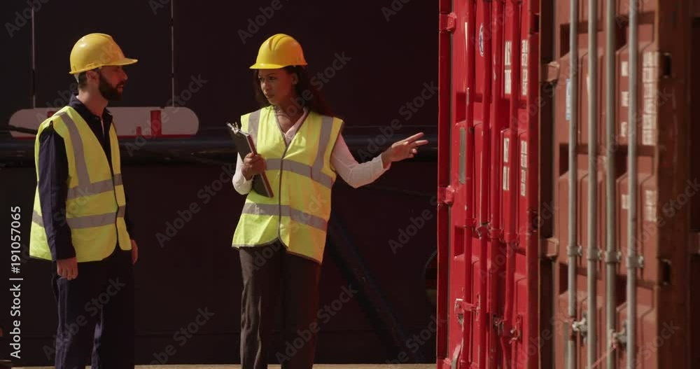 Two dock workers conferring among themselves while surveying the harbor. Shot on RED Epic. Two dock workers conferring among themselves while surveying the harbor. Shot on RED Epic.