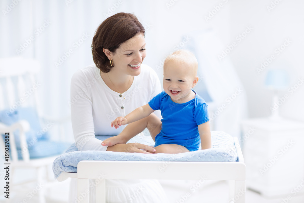 Mother and baby on changing table Mother and baby on changing table