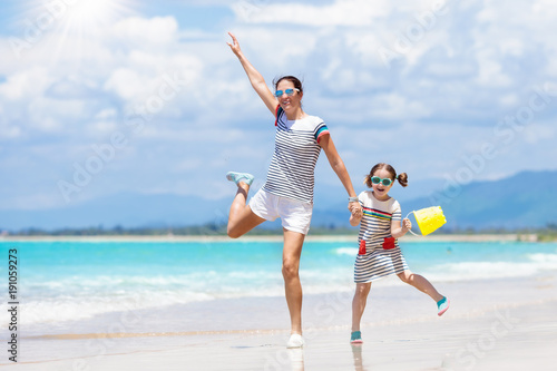 Mother and child on tropical beach. Sea vacation © famveldman