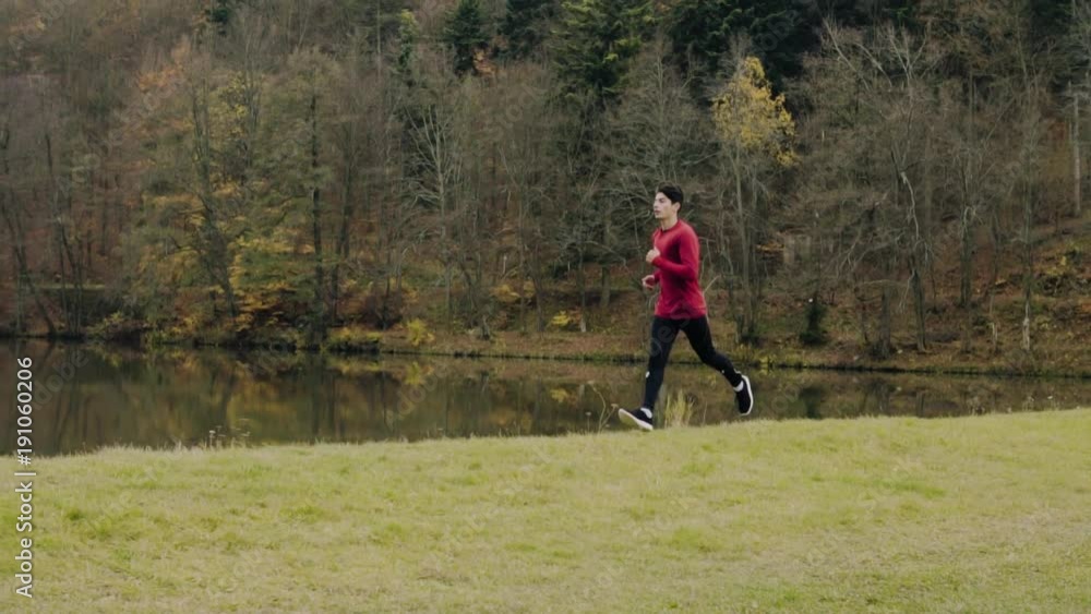 Young handsome man running in autumn nature. Young handsome man running in autumn nature.