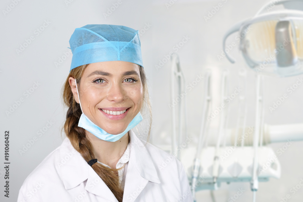 Portrait of a beautiful dentist smiling showing a perfect smile, on professional clinic. Concept of: portrait, doctor, medical, successfull Portrait of a beautiful dentist smiling showing a perfect smile, on professional clinic. Concept of: portrait, doctor, medical, successfull