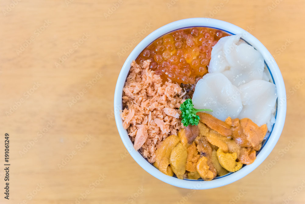 Japanese food with raw fishes ,Sea urchin and scallop called sashimi on the rice in Bowl in Hakodate morning market, Hokkaido, Japan. Japanese food with raw fishes ,Sea urchin and scallop called sashimi on the rice in Bowl in Hakodate morning market, Hokkaido, Japan.