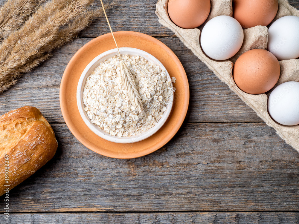 Ingredients for Breakfast Oatmeal Eggs Bread Apple Rustic Wooden background Copy space Ingredients for Breakfast Oatmeal Eggs Bread Apple Rustic Wooden background Copy space