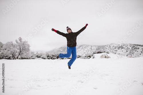 Woman jumping on the snow.