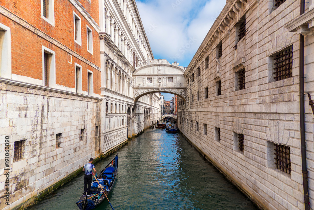 Gondolas floating on canal towards Bridge of Sighs (Ponte dei Sospiri). Venice, Italy