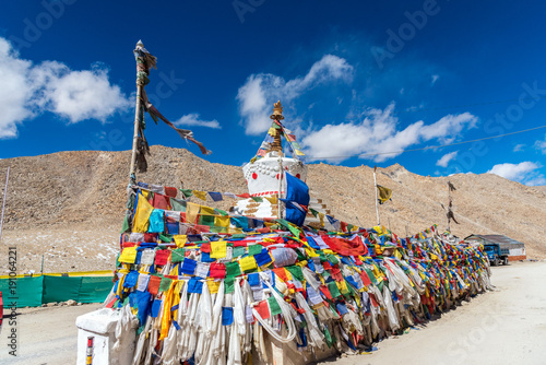 White Tibet style pagoda and Prayer flags at Khardungla Pass, the highest motorable pass in the world, ladakh, Jammu and Kashmir, India photo