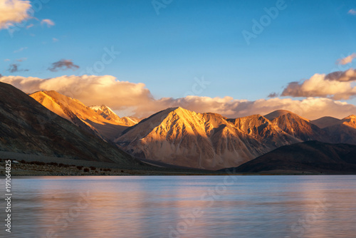 Mountains and Pangong tso (Lake). It is huge and highest lake in Ladakh and blue sky in background, it extends from India to Tibet. Leh, Ladakh, Jammu and Kashmir, India photo