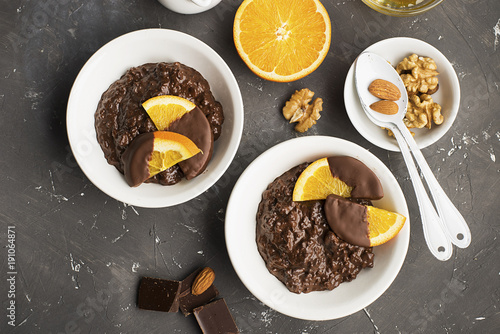 Chocolate rice pudding porridge risotto with oranges in chocolate for breakfast. Top view..