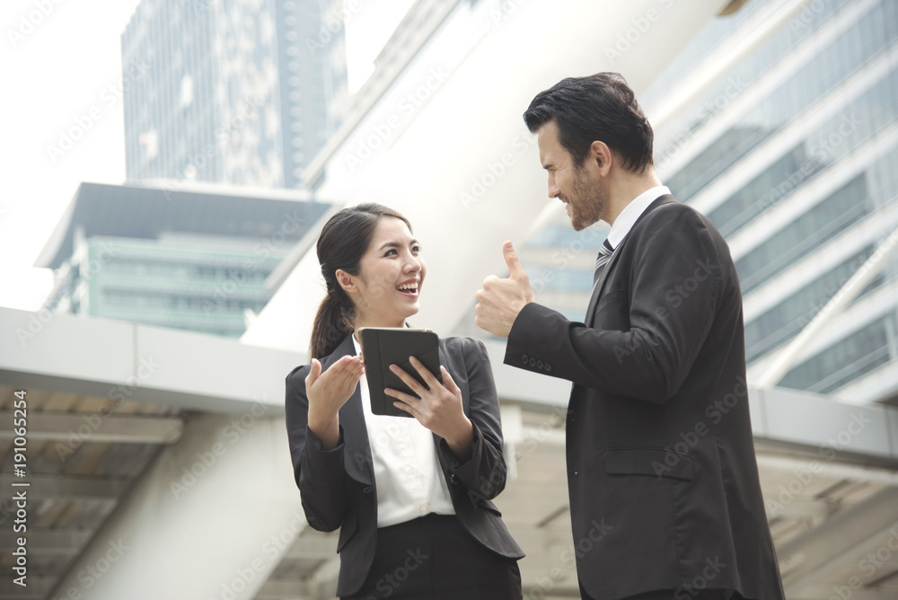 Businessman and businesswoman partner consulting and discussing at outdoor. Businessman and businesswoman partner consulting and discussing at outdoor.