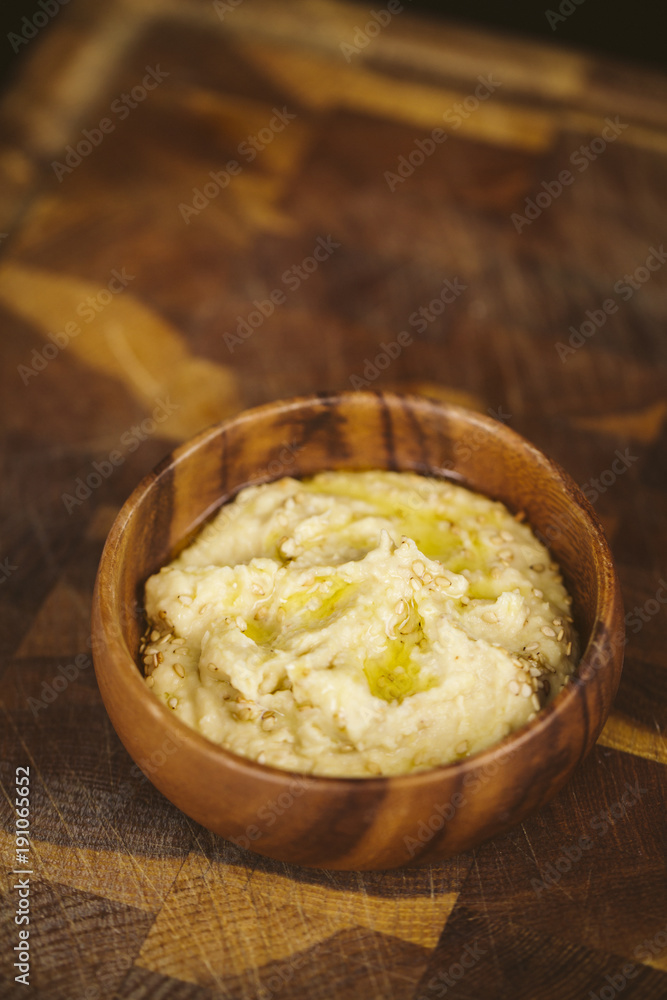 Hummus bowls. Chickpea hummus on wooden table. Hummus bowls. Chickpea hummus on wooden table.