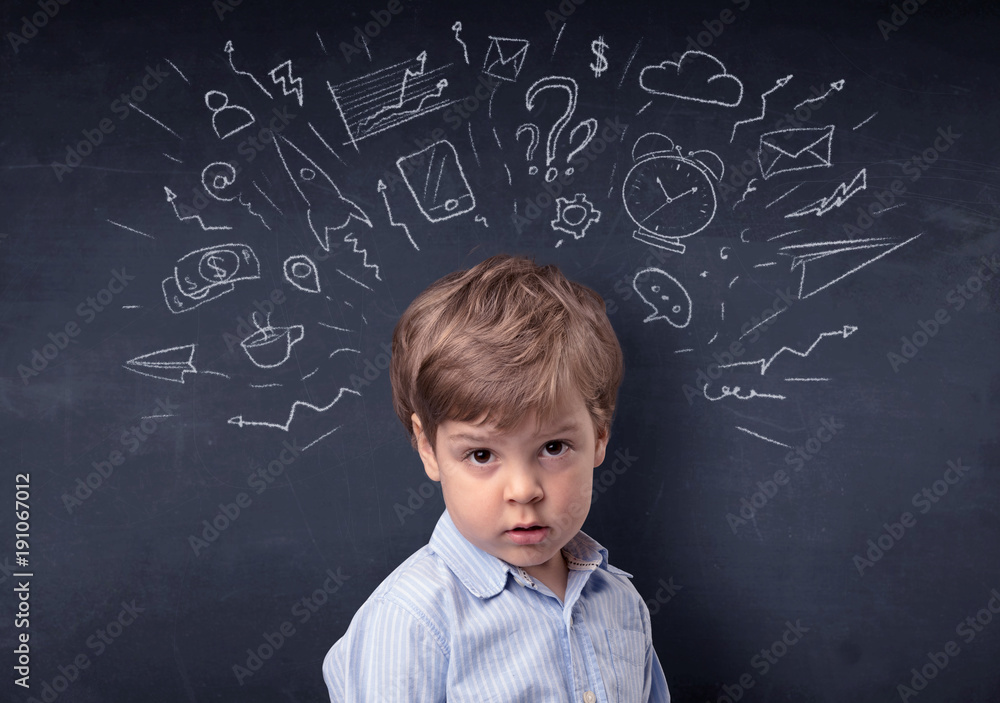 Little boy in front of a drawn up blackboard Little boy in front of a drawn up blackboard