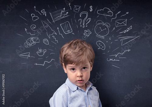 Little boy in front of a drawn up blackboard © ra2 studio