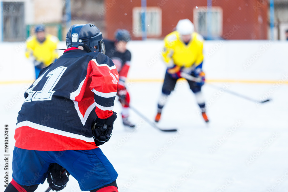 Obraz premium Unrecognizable ice hockey player with stick in attack. Ice hockey game on rink