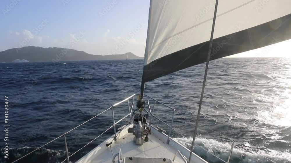 sailboat approaching a caribbean island sailboat approaching a caribbean island