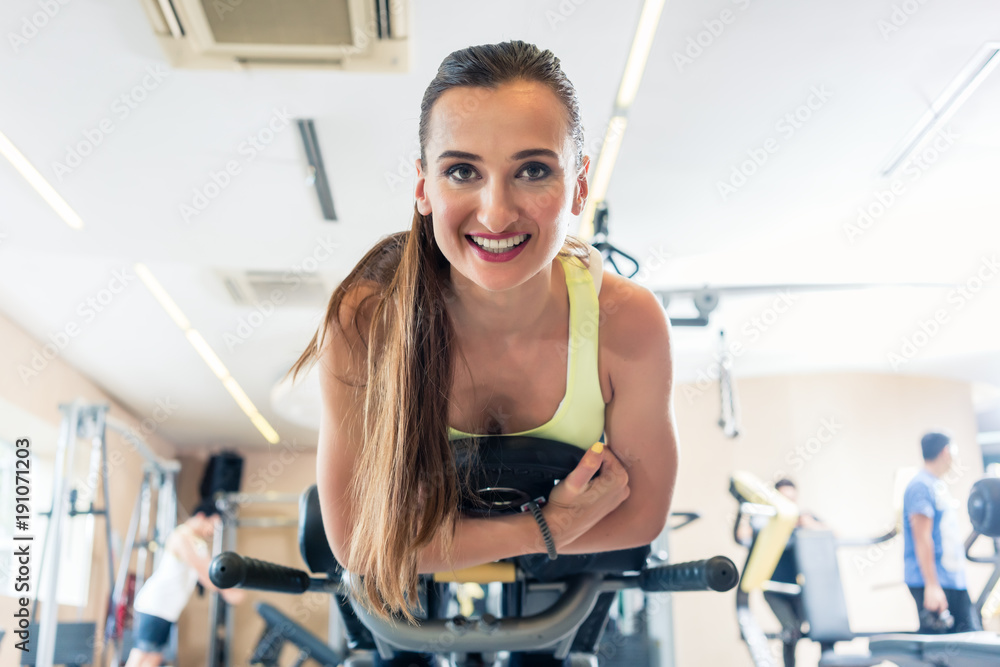 Low-angle view portrait of a cheerful woman during cycling workout Low-angle view portrait of a cheerful woman during cycling workout