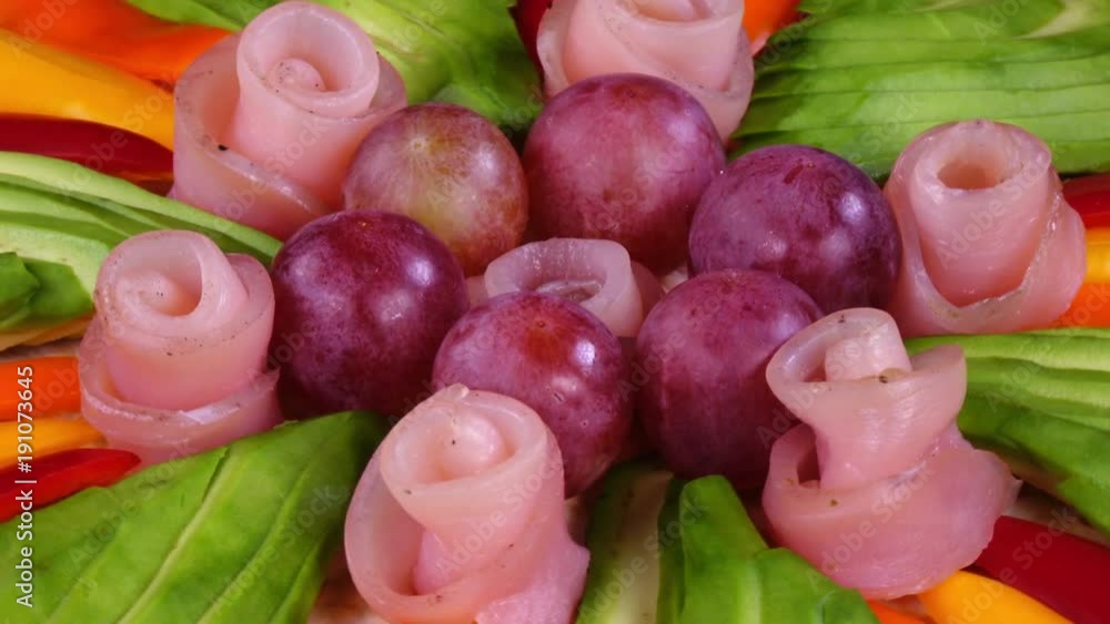 Closeup view of handmade colorful pizza with avocado, pepper, grape and ham rotates in 4K.
Closeup view of handmade colorful pizza with avocado, pepper, grape and ham rotates in 4K.