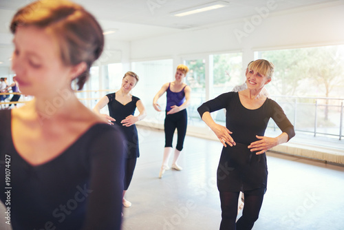 Group of mature women dancing ballet in class together © Flamingo Images