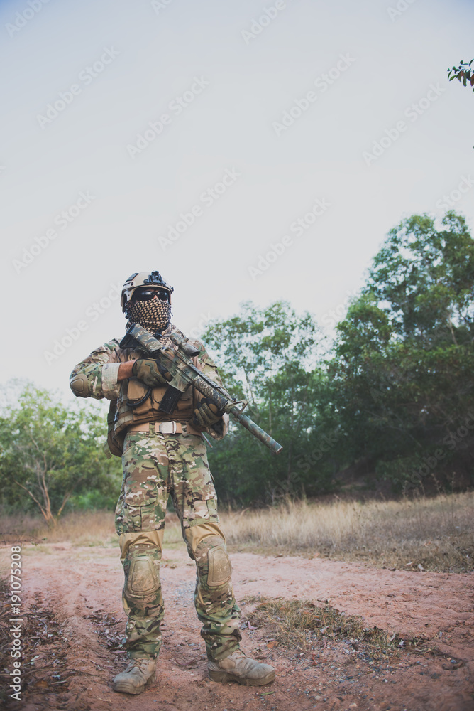 Fototapeta premium Closeup asian soldier with weapons in hand at the forest,prepare for maneuver,military veterans concept,Thailand army