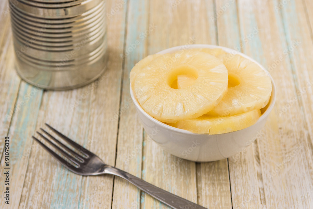 Canned pineapple rings. Ananas slices in a white bowl Canned pineapple rings. Ananas slices in a white bowl
