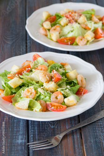 Caesar salad with shrimps, cherry tomato, croutons, salad leaf and parmesan cheese