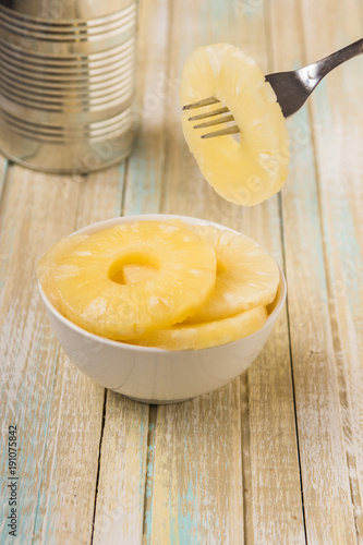 Canned pineapple rings. Ananas slices in a white bowl