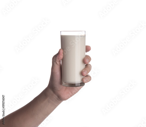 Hand holding glass of milk isolated on white background