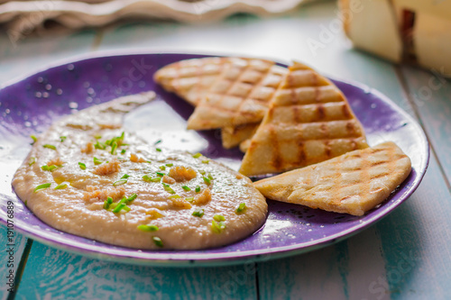 Taramasalata and pita grill on a ceramic violet plate side view