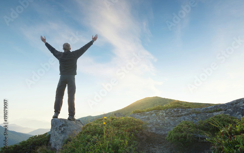 Silhouette of a winner on mountain top. Sport and active life concept. © biletskiyevgeniy.com