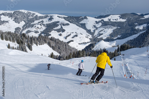Skier starts his journey in winter, with mountains in switzerland photo
