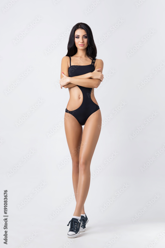 Fit, healthy and sporty girl in swimsuit. Sport, fitness, diet and healthcare concept. Fit, healthy and sporty girl in swimsuit. Sport, fitness, diet and healthcare concept.