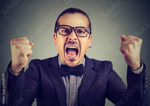 Formal man screaming in anger