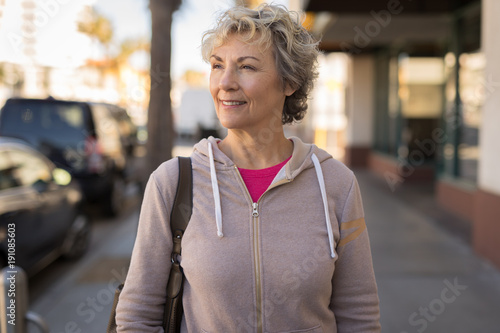 Mature caucasian woman walking smile face