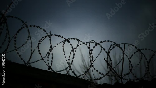 Barbed wire fencing. Closed territory on a secret facility. Places of imprisonment or prison.