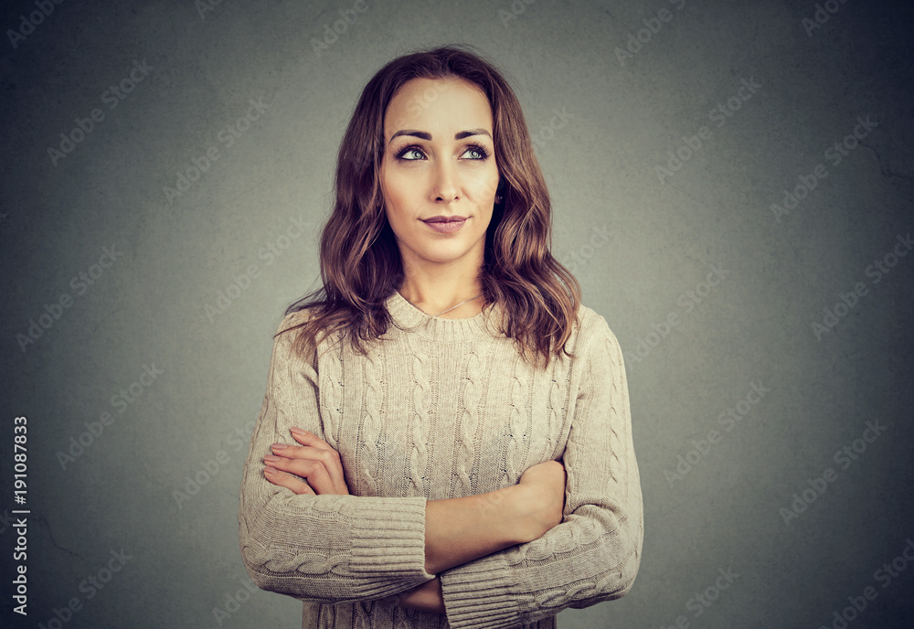 Woman looking offended while posing on gray Woman looking offended while posing on gray