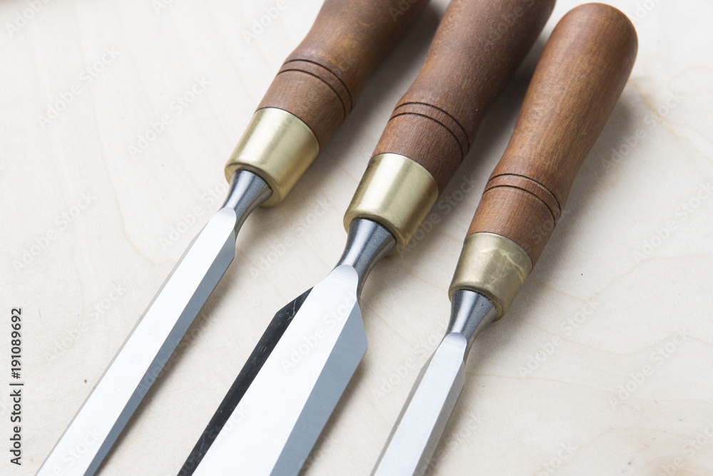 professional chisels on a wooden background