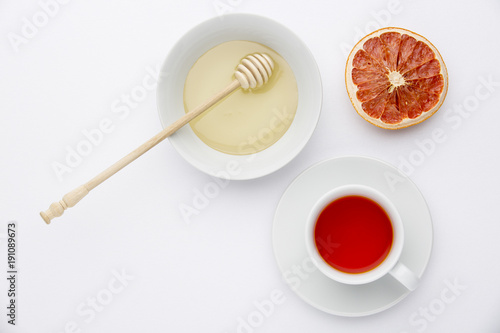 tea with honey in a glass on a white background