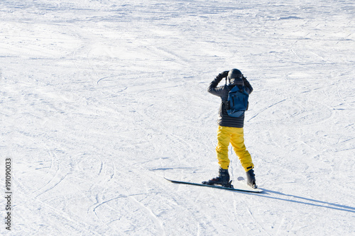 BUKOVEL, UKRAINE- 27 JANUARY 2018: Man on skis looks afar. View from the back