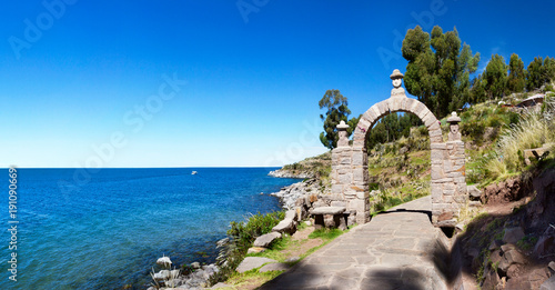 The entrance stone arch leading to the interior of Taquile Island in Lake Titicaca, Peru    photo