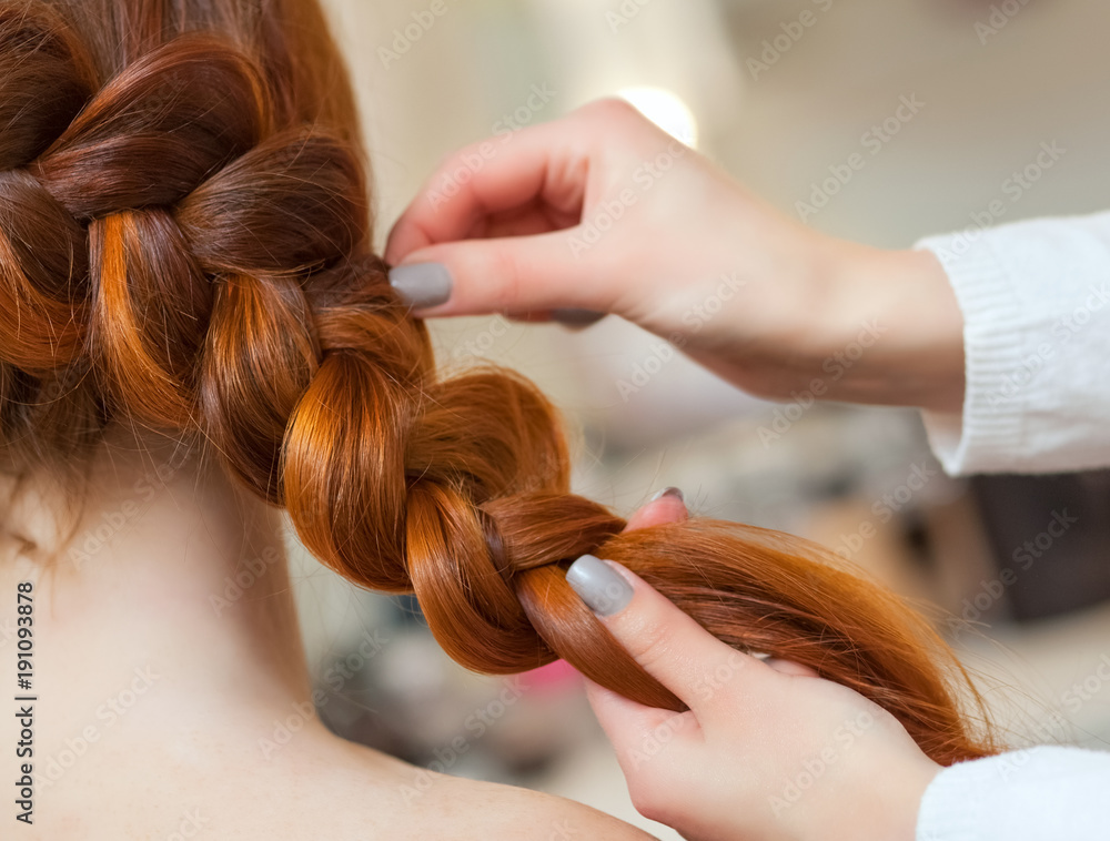 Beautiful girl with long red hair, hairdresser weaves a braid, in a beauty  salon. Professional hair care and creating hairstyles. Stock Photo | Adobe  Stock