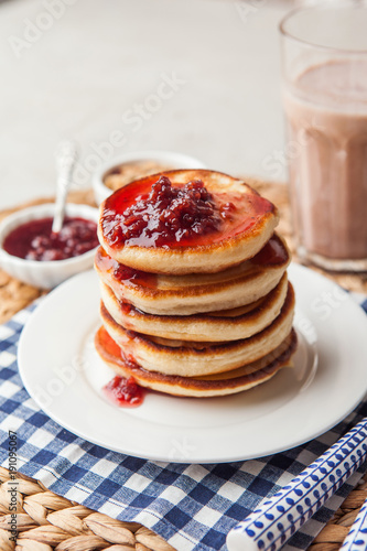 Pancakes stack on a plate with raspberry jam. Shrove Tuesday, pancake day, Maslenitsa. Traditional Russian holiday