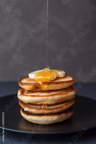 Pancakes with banana and honey for a breakfast. Shrove Tuesday, pancake day,