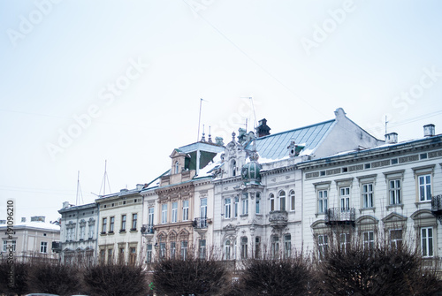 Pale blue facades of the architectural old houses in the city center of Lviv, Ukraine. Blue winter sky on the background.