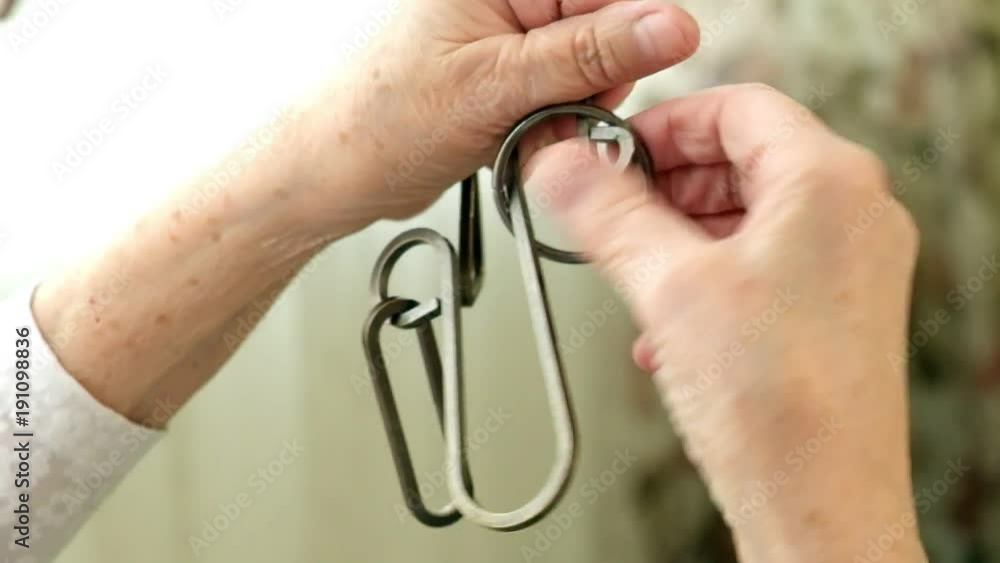 An old woman unravels a metal puzzle, coaches brain activity An old woman unravels a metal puzzle, coaches brain activity