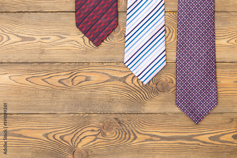 Obraz premium Happy father's day concept with ties on a wooden background. Place under the text