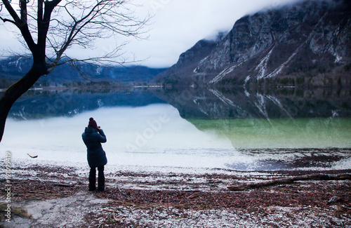 woman taking pictures at Bohinj lake  Slovenia