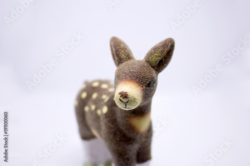 A toy deer souvenir.  Delicate  interesting toy close-up  on white background