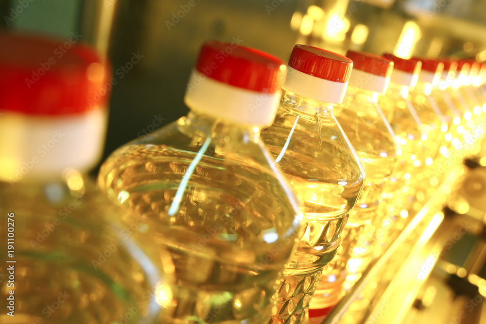 Sunflower oil. Line for the production and bottling of refined oil from sunflower seeds. Conveyor of food industry Sunflower oil. Line for the production and bottling of refined oil from sunflower seeds. Conveyor of food industry